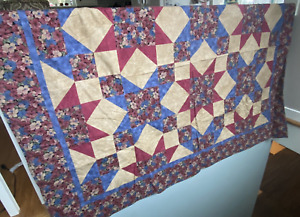Handmade burgundy and purplish blue floral quilt with brown squares. 56" x 66"