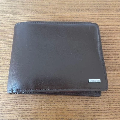 Cartera plegable de cuero marrón Porter para hombre usada Foto 1 de 4