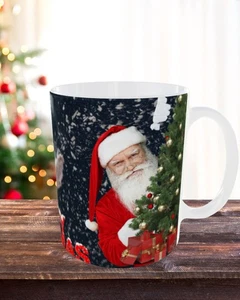 11 oz Christmas Mug – Santa Claus Celebrating & Hiding Behind the Christmas Tree - Picture 1 of 5