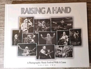 Raising a Hand : A Photographic Music Festival with a Cause (2016, HC) Volume 2 - Picture 1 of 6
