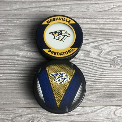 Lot of 2 Nashville Predators NHL Team Logo Souvenir Hockey Pucks - Image 1 of 4