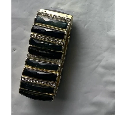 Pulsera elástica de diamantes de imitación con gema negra tono dorado para mujer Foto 1 de 2