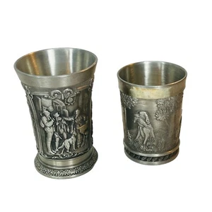 2 vasos de chupito en relieve SKS de peltre de Alemania Occidental antiguos escenas de panel personas animales - Imagen 1 de 22