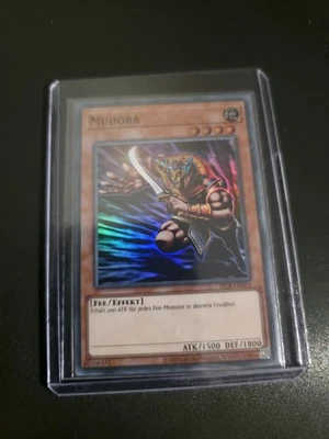 Yu-Gi-Oh! Mudora DCR-DE076 - NEAR MINT - Super Rare - NEU + UNBESPIELT - Deutsch - Bild 1 von 4