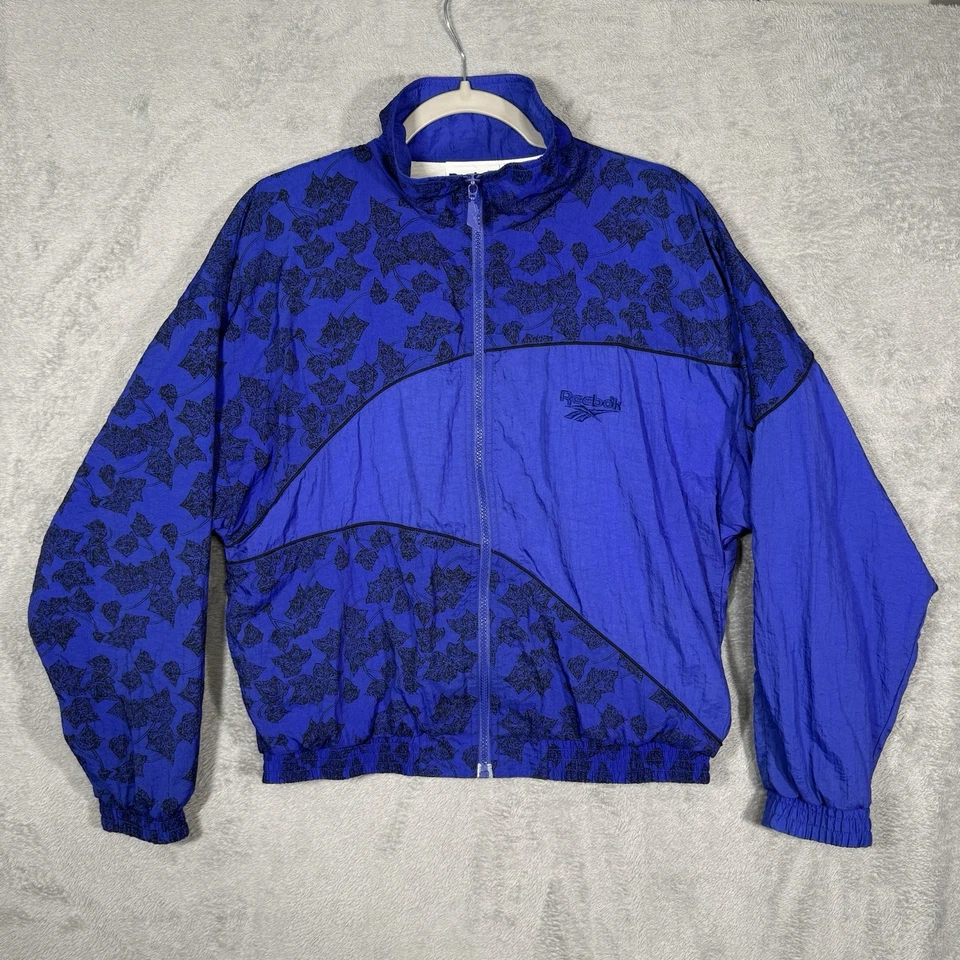 Chaqueta cortavientos de colección Reebok años 90 talla M estampado de hojas azul negro nailon pista retro Foto 1 de 4