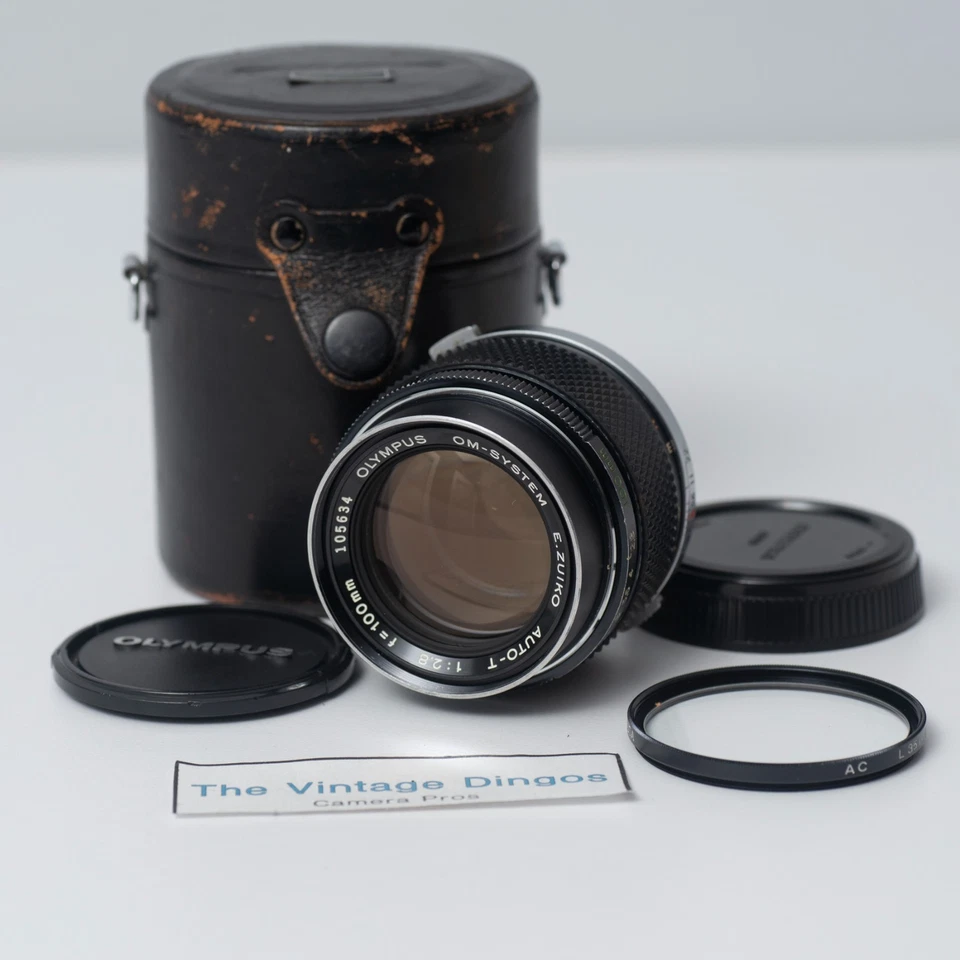 Lente Olympus OM-SYSTEM E.Zuiko Auto-T 100 mm f/2,8 MF con tapas + filtro Foto 1 de 4