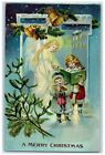 C1910's Christmas Mistletoe Angel And Children Pine Cone Bells Embossed Postcard