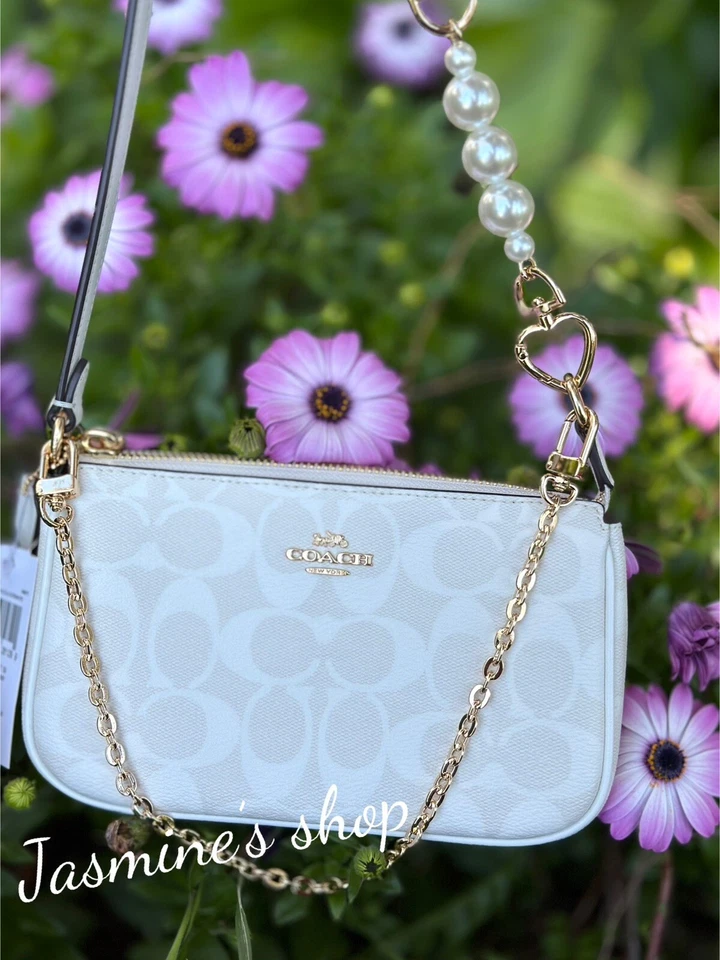Coach Nolita 19 In Signature Canvas CS442 an extended floral chain