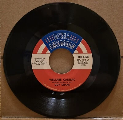 Guy Drake - Welfare Cadilac/Keep Off My Grass - Vinyl Record 45 RPM 7" Foto 1 de 2