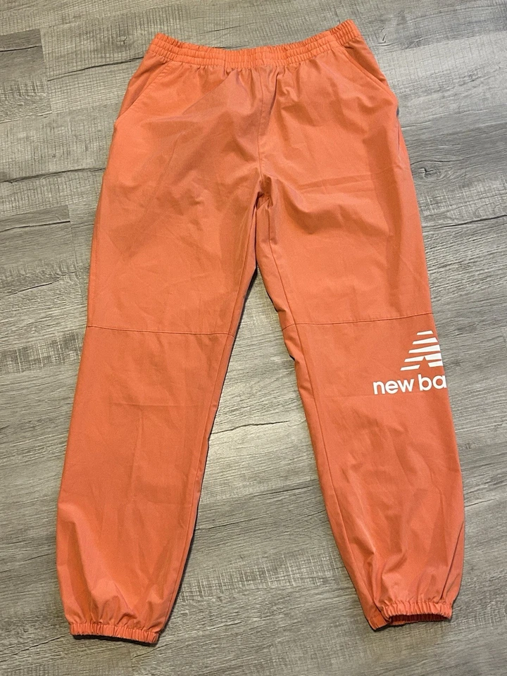 Calça atlética jogger feminina New Balance, pêssego, leve, tamanho grande - Imagem 1 de 4