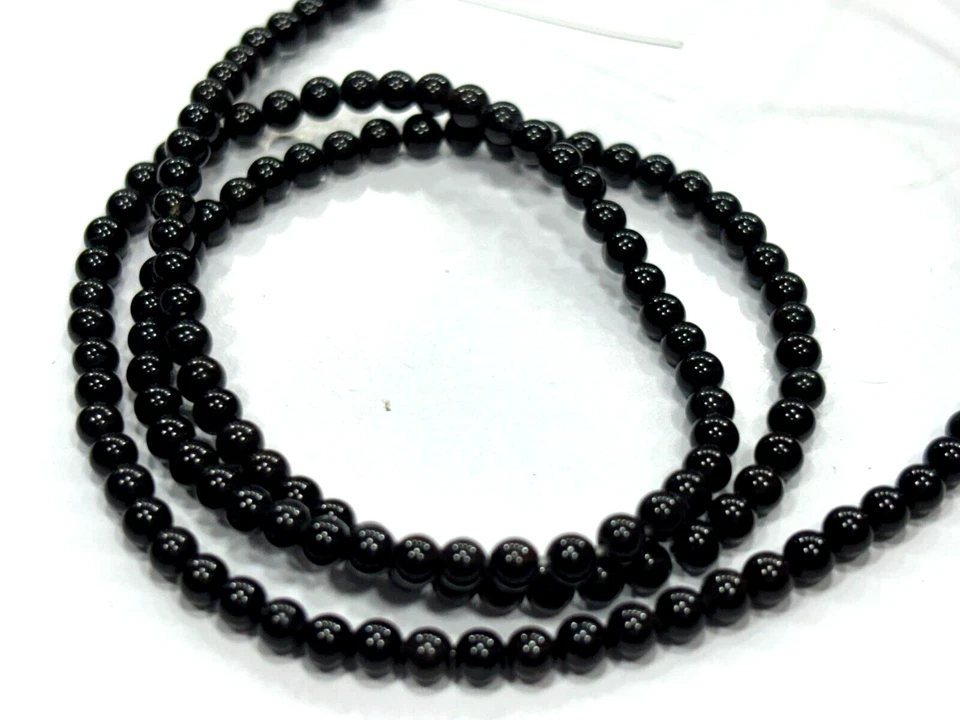 CUENTAS DE PIEDRAS PRECIOSAS REDONDAS LISAS DE ÓNIX NEGRO DE 3-3,5 MM 1 HEBRA 14 PULGADAS Foto 1 de 4