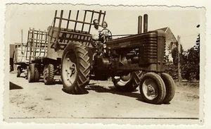 FATHER GIVES DAUGHTER A RIDE ON HIS BIG JOHN DEERE TRACTOR (1948) - Picture 1 of 3