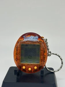 Conexión Tamagotchi V1 naranja claro/transparente con destellos/brillo. ¡Raro! - Imagen 1 de 4