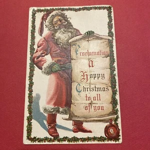FRÜHE 1900ER GEPRÄGTE WEIHNACHTSPOSTKARTE WEIHNACHTSMANN HÄLT EINEN WEIHNACHTSPROC - Bild 1 von 2