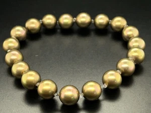 SCHMUCKJAGD FLEX-ARMBAND MIT MUSCHELKERNPERLEN - Imagen 1 de 3