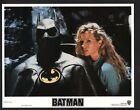 POSTER: Batman Lobby Card-Kim Basinger standing next to the Batsuit.