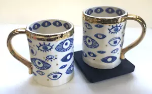 Anthropologie Insight Set of 2 Mugs Hamsa Blue Evil Eyes Stoneware Gold Trim - Picture 1 of 8