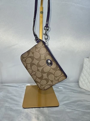 Cartera sin asas Coach Signature marrón púrpura Foto 1 de 4