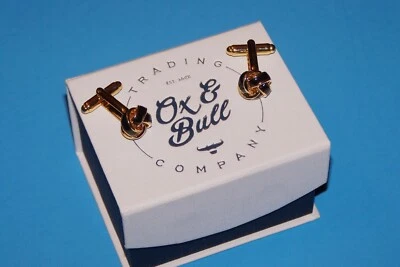 Gemelos anudados en tono negro y dorado 2O18 OX & Bull Trading Company Foto 1 de 4
