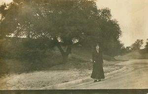 Vintage RPPC 1911 Aunt Nellie, Long black dress standing in the street - Picture 1 of 2