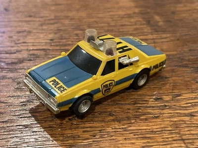 Aurora AFX Chevrolet Caprice Police Yellow Blue Clear Lights HY-71 HO Slot Car - Image 1 of 3