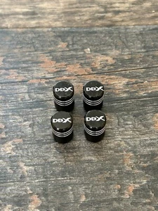 4 Piece Set of Black Tyre Valve Caps For Aston Martin DBX SUV V8 - Picture 1 of 3