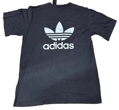 Camiseta negra vintage con logotipo del trébol Adidas doble cara talla grande años 90 L golpeada Foto 1 de 4