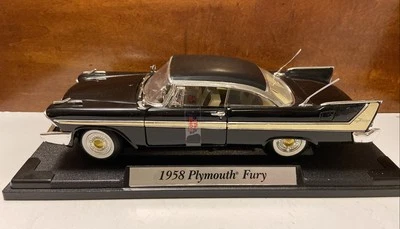 MOTOR MAX DIECAST NEGRO 1958 PLYMOUTH FURY MODELO DE COCHE ESCALA 1:18 CON SOPORTE Foto 1 de 4