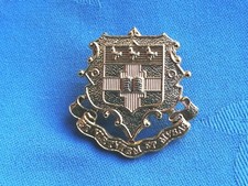 The Mill Hill School Combined Cadet Force cap badge.