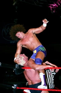 CARLITO PUNCHING RIC FLAIR VINTAGE 8x10 COLOR PHOTO ROH ECW WWF NXT AEW NXT WWE - Picture 1 of 1