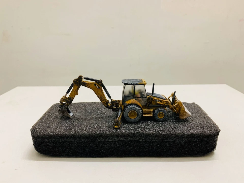 Cat 450E Backhoe Loader Muddy Edition 1:87 Ho Scale By Diecast Masters 85263 - Image 1 of 4