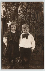 Postcard Vintage RPPC Two Kids Posing in Their Sunday Best - Picture 1 of 2