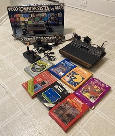 atari 2600 Wood grain console With 2 Joysticks, 2 Paddle Controls And 7 Games!