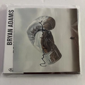NEW HAND SIGNED TO COVER BRYAN ADAMS ROLL WITH THE PUNCHES HIS NEW CD SEALED - Picture 1 of 3