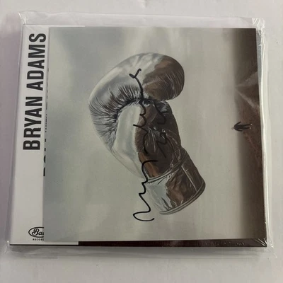 NEW HAND SIGNED TO COVER BRYAN ADAMS ROLL WITH THE PUNCHES HIS NEW CD SEALED