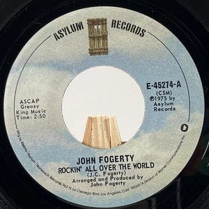 JOHN FOGERTY 45 RPM ROCKIN’ ALL OVER THE WORLD / THE WALL—NM - Imagen 1 de 6