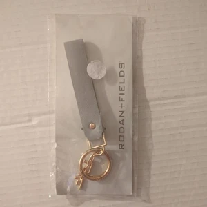 NWT Rodan and Fields gray leather & gold metal signature R&F charm key chain - Picture 1 of 3