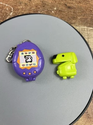 Vintage Bandai Tamagotchi Purple with Green Dog Inside McDonald's 1997 Keychain - Image 1 of 4
