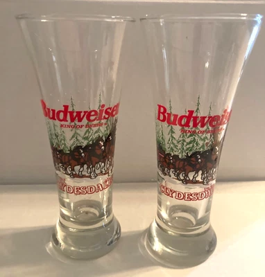Pair Budweiser Clydesdales Pilsner Beer Glasses. Winter Scene 7" Tall 1996 - Image 1 of 4