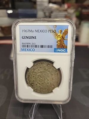 1967-Mo Mexico 1 Peso – NGC Certified GENUINE 10% Silver  - Image 1 of 2