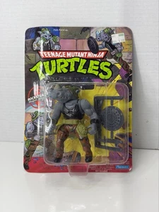 Figura de acción de colección 1988 TMNT Rocksteady Playmates nueva sin usar, en caja 10 reverso - Imagen 1 de 12