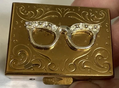 Vintage 1 1/2” Goldtone Metal Pill~Trinket Box W/Rhinestone Eye Glasses Decor - Image 1 of 4