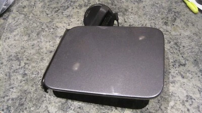 2017 Nissan Versa Sedan Fuel Door OEM #KAD Gun Metal Color with Cap - Image 1 of 2