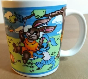 Bunnies on a swing ceramic coffee cup/mug Sherwood Brands - Picture 1 of 6