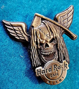 MIAMI BRONZE WINGED 3D SKULL SERIES LONG HAIR ZOMBIE AXE Hard Rock Cafe PIN LE - Picture 1 of 1