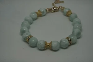 A handmade bracelet made of natural angelite stone with brass inserts on an adju - Picture 1 of 6
