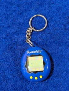 Bandai TamaGotchi Original - Azul con estampado plateado y botones amarillos - 1996 - 1997  - Imagen 1 de 3