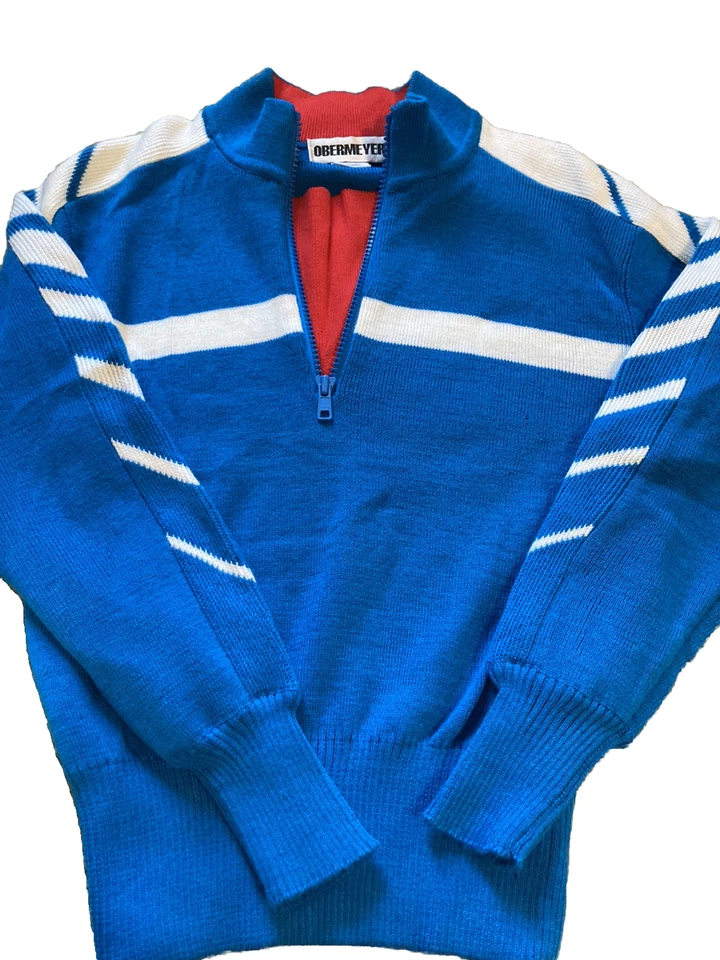Suéter de esquí Obermeyer para niños Stinger talla 12, azul y blanco, ribete rojo. Foto 1 de 4
