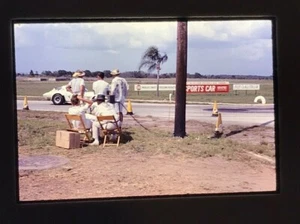 1960's Sebring FL 12 hour 1965 Race Team observing sitting near race track - Picture 1 of 5