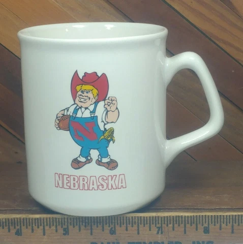 Vintage Nebraska Cornhuskers NCAA Football Team Mascot Herbie Husker Coffee Mug Cover